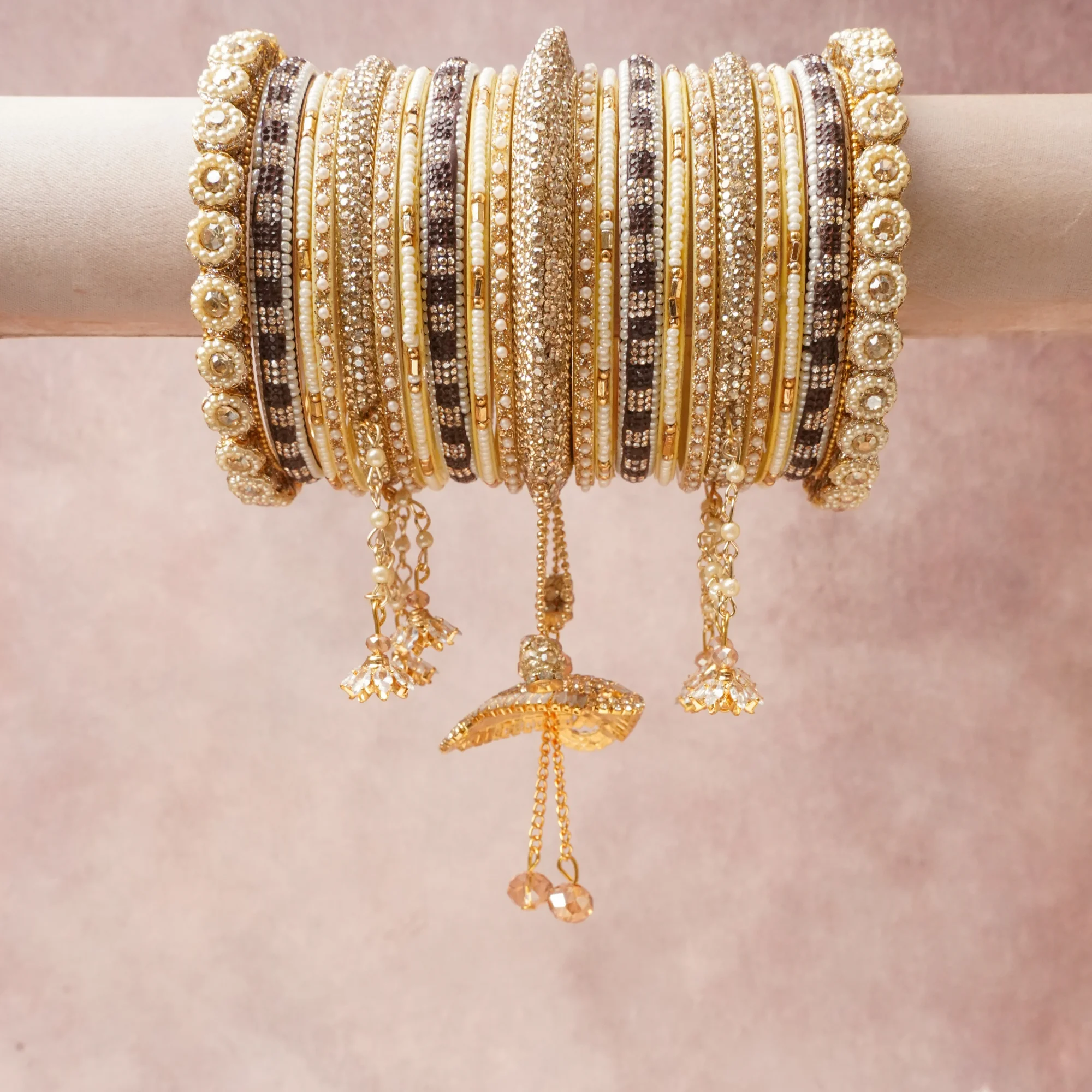 A commanding Gold anchors this beautiful set, enriched with accents of Clear, Pearl White, Champagne that add depth and dimension.

Featuring a striking composition of Gold-toned Metal, Cubic Zirconia, Faux Pearl, Glass, Enamel, this set carries intricate craftsmanship and strong presence. Grand in form, it is created for moments that deserve to be marked.